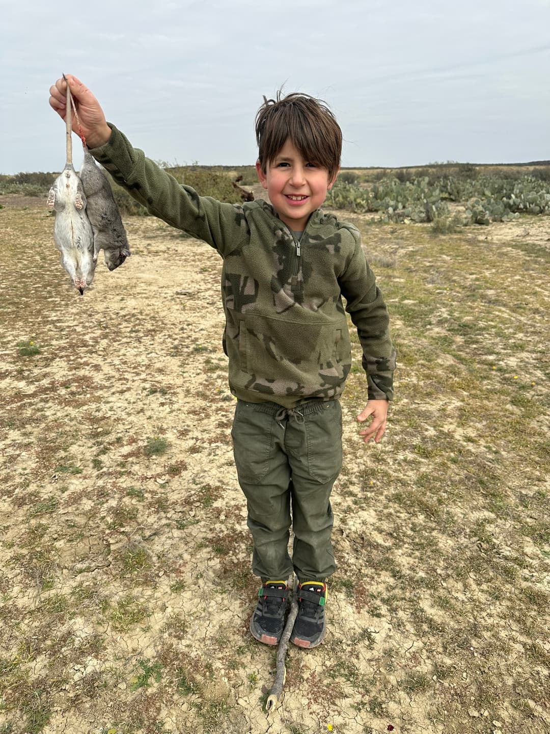 Young hunter proudly displaying his small game harvest